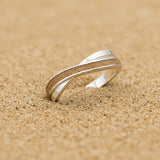 Ring with sand · Crossed silver band with sand or earth
