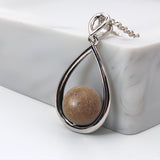 Pendant with sand · Silver and pearl drop or teardrop with sand or earth