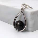 Pendant with sand · Silver and pearl drop or teardrop with sand or earth
